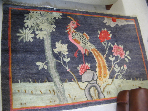 Appraisal: PICTORIAL CHINESE AREA RUG the plain blue field featuring a