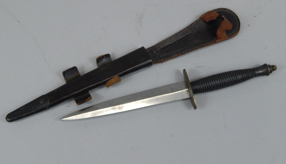 Appraisal: An F Sykes Commando knife with bronzed copper handle brass