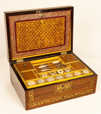 Appraisal: A Regency rosewood workbox the cover inlaid brass scrolls and