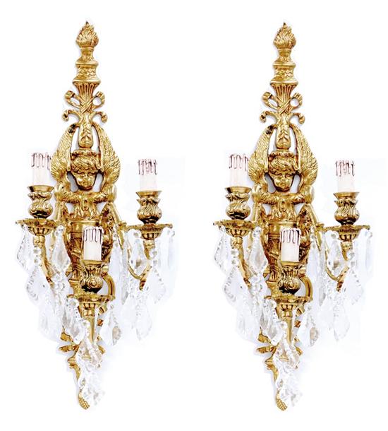 Appraisal: Pair gilt-metal and crystal three-light sconces backplate of putti issuing