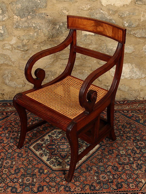 Appraisal: A REGENCY STYLE MAHOGANY METAMORPHIC LIBRARY CHAIR with scroll arms