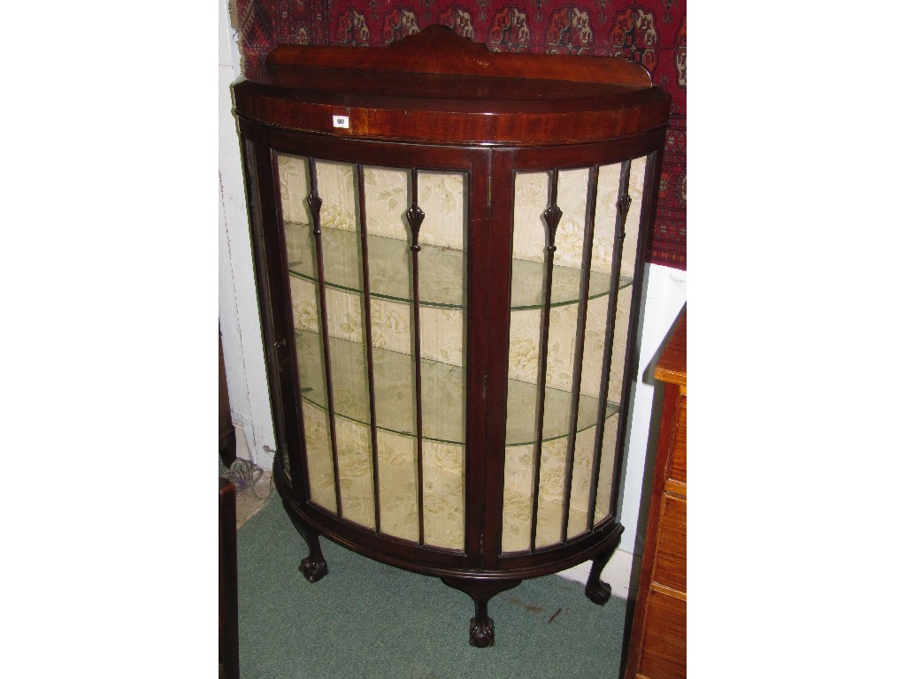 Appraisal: Mahogany bow front display cabinet on ball and chair supports