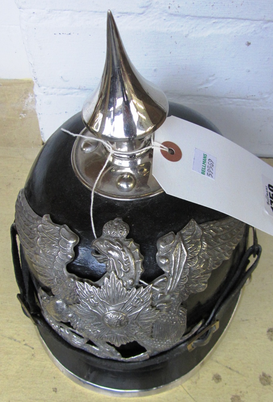 Appraisal: A German picklehaube style helmet black leather skull with brass