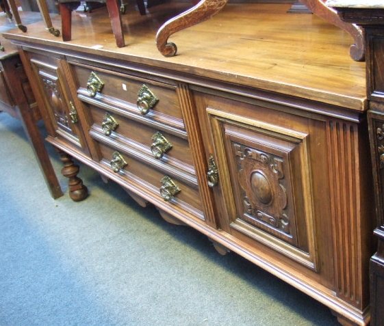 Appraisal: An Edwardian walnut sideboard with a ledge back and three