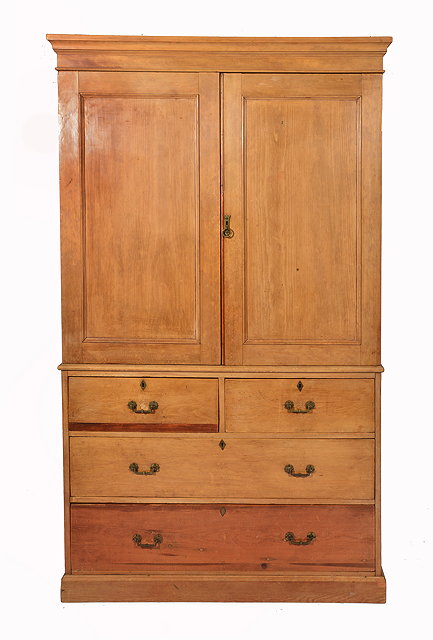 Appraisal: A LATE VICTORIAN PINE LINEN PRESS with two panelled doors