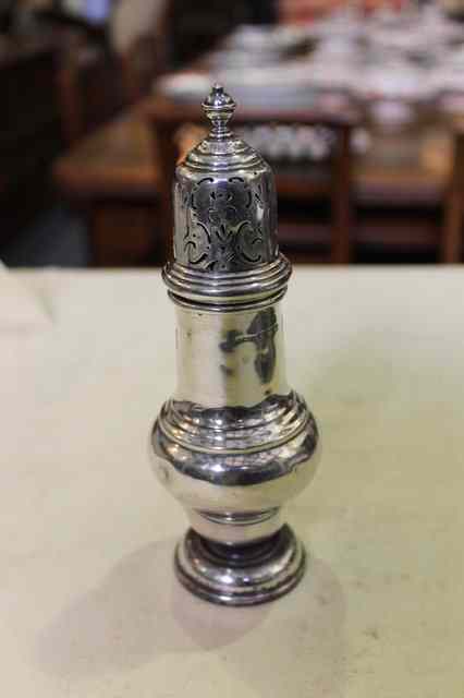 Appraisal: A GEORGIAN STYLE SILVER CASTER of baluster form on pedestal