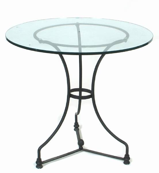 Appraisal: A wrought iron and glass circular center table height in