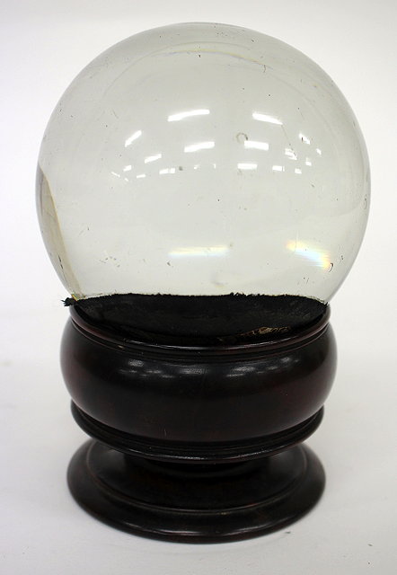 Appraisal: AN ANTIQUE CRYSTAL BALL on Georgian turned mahogany stand cm