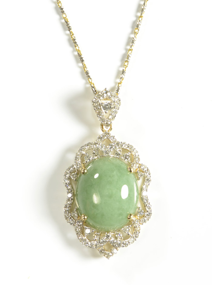 Appraisal: JADEITE JADE AND DIAMOND PENDANT NECKLACE suspended on an inch