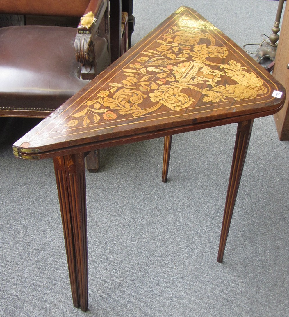 Appraisal: A th century marquetry inlaid rosewood triangular foldover card table