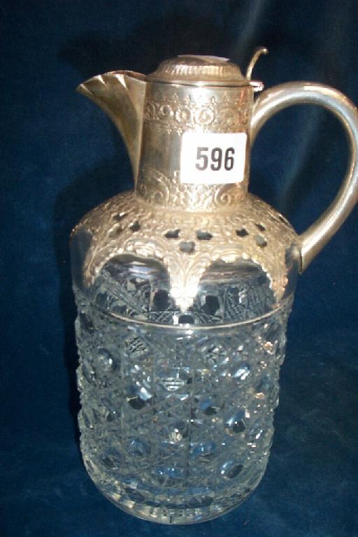 Appraisal: A cut glass decanter of cylindrical form with embossed silver