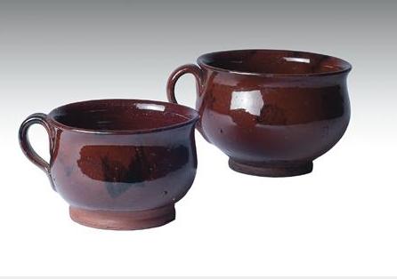 Appraisal: TWO NEW ENGLAND OR NEW YORK GLAZED REDWARE CHAMBER MUGS