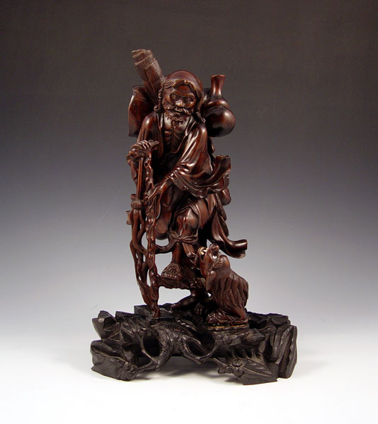 Appraisal: CARVED WOOD ASIAN FIGURE WITH DOG Traveler with dog at