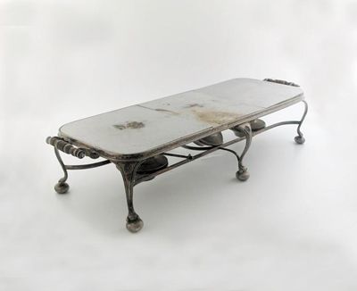 Appraisal: A large plated warming stand with twin handles three spirit