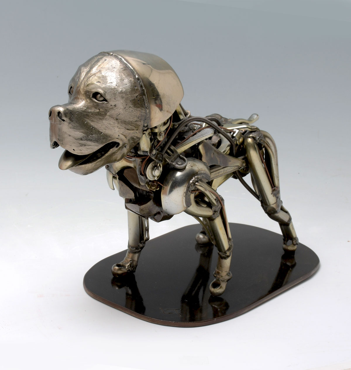 Appraisal: WELDED DOG SCULPTURE ''Barcalo'' welded from steel machine parts with