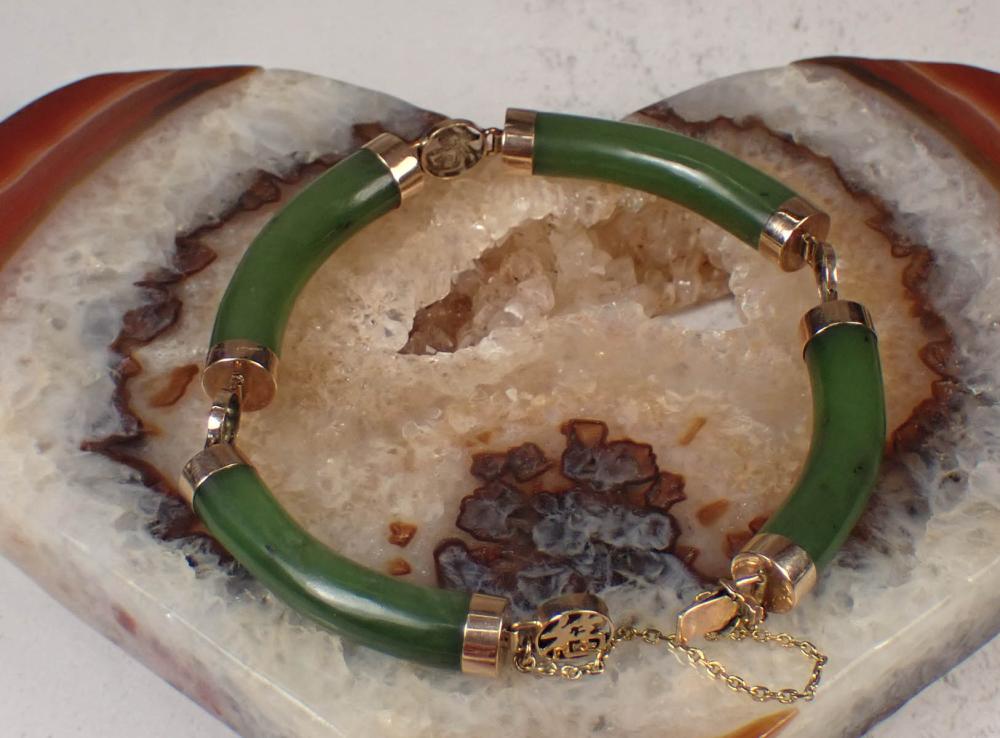 Appraisal: NEPHRITE JADE AND YELLOW GOLD BRACELET with four curved nephrite