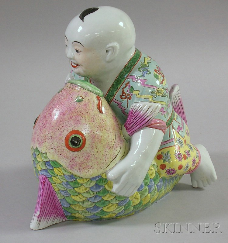 Appraisal: Asian Ceramic Figure of a Boy Sitting on a Fish