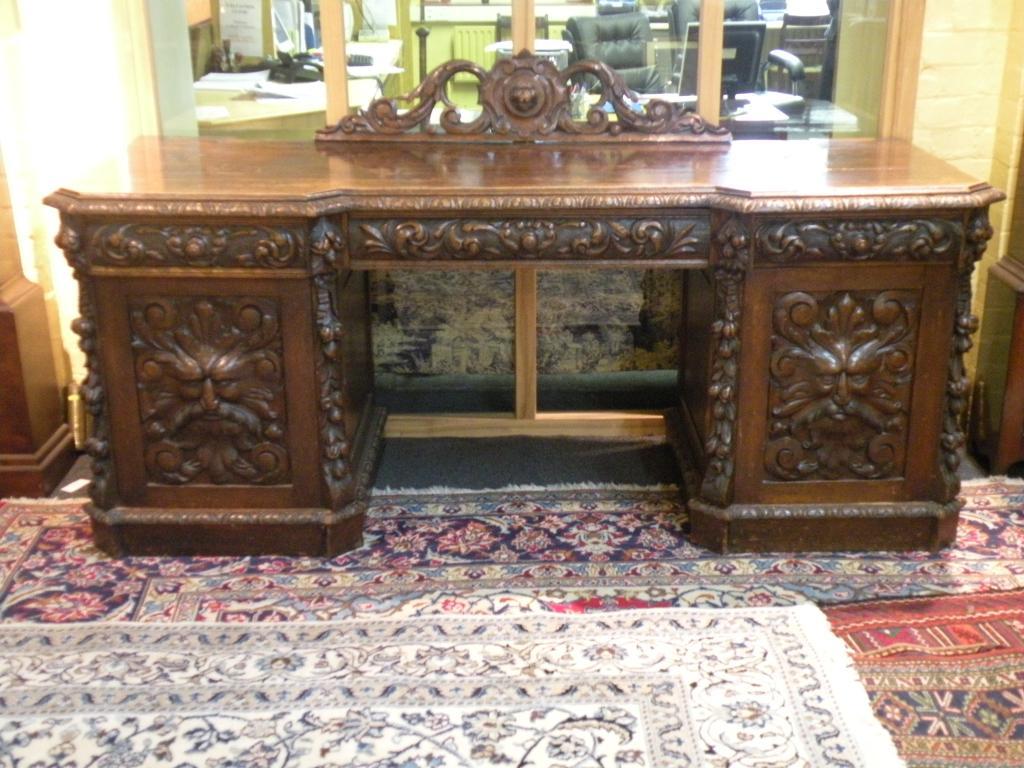 Appraisal: A Victorian carved oak pedestal sideboard with a raised back