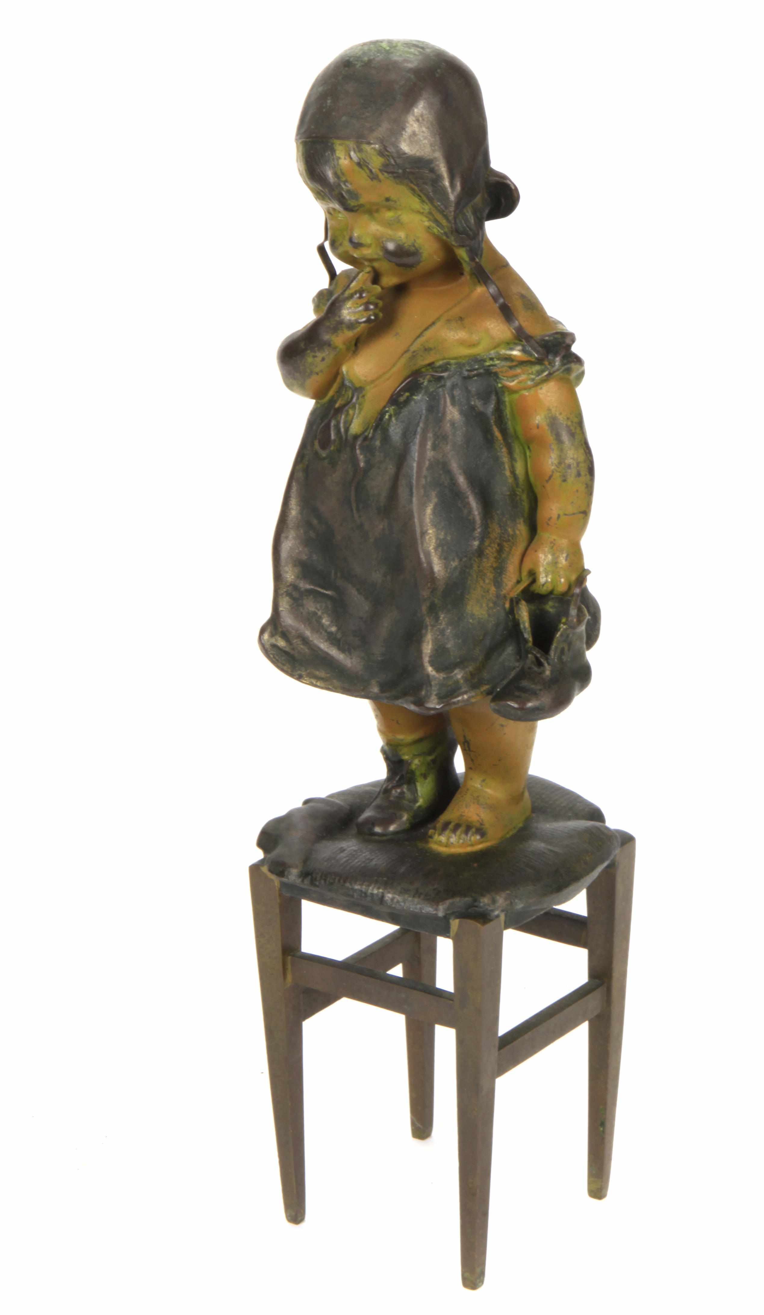 Appraisal: A spelter and bronze figure of a child standing on