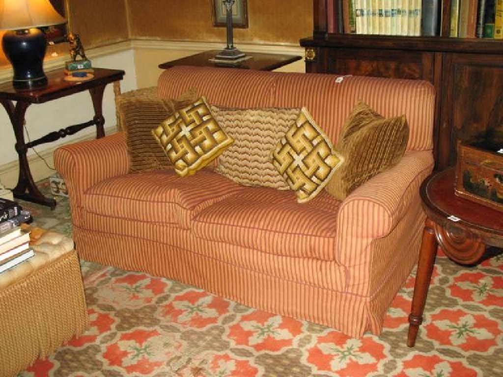 Appraisal: A TWO SEATER SOFA with terracotta striped loose covers wide