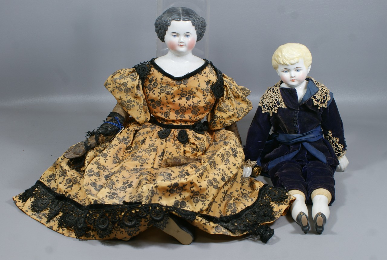 Appraisal: Glazed China Head Dolls larger with molded black hair is