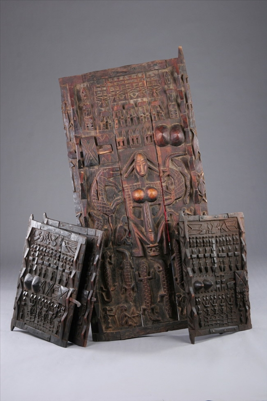 Appraisal: FOUR DOGON WOOD GRANARY DOORS Carved in relief to depict