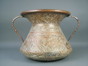 Appraisal: A Continental copper twin handled vase with flared neck embossed