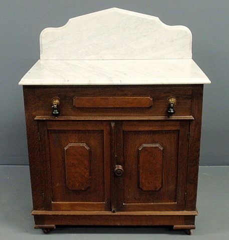 Appraisal: Victorian walnut washstand with marble top and paneled doors h