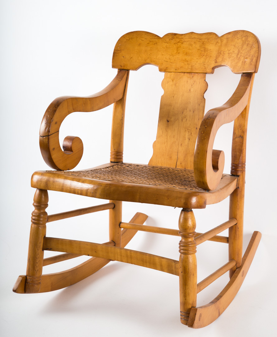 Appraisal: American bird's-eye maple child's rocking chair ca shaped crest rail