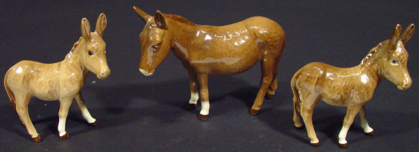 Appraisal: Three Beswick donkeys each with hand painted brown decoration printed