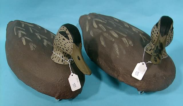 Appraisal: Pair of Herters burlapped resin Black Duck Gunning decoys