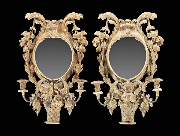 Appraisal: A pair of Continental carved fruitwood girandoles height in width