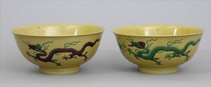 Appraisal: PAIR OF CHINESE YELLOW-GROUND PORCELAIN DRAGON BOWLS With impressed -character