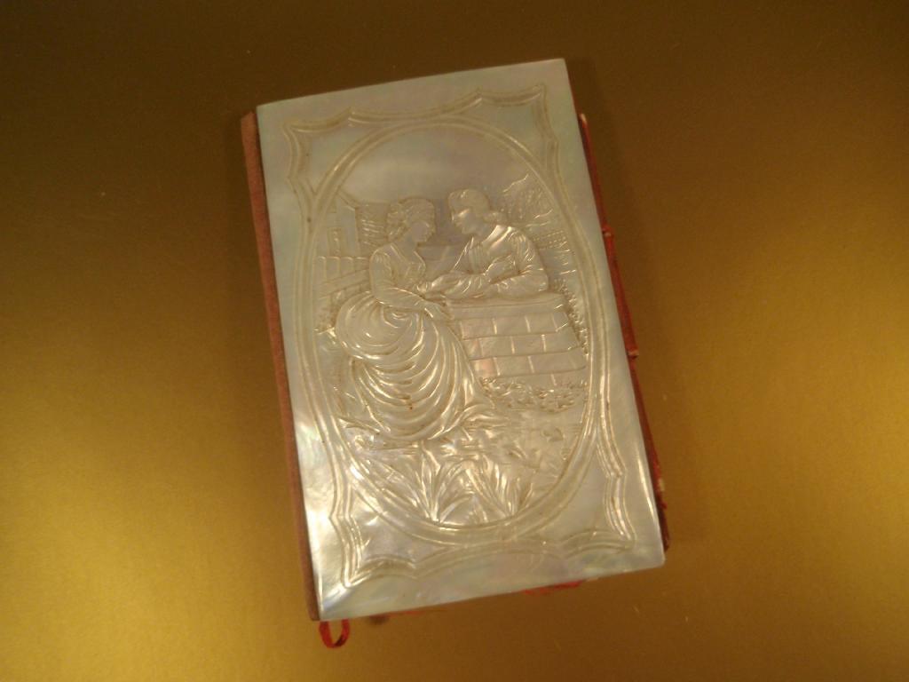 Appraisal: A mother-of-pearl card case purse with carved scene to front