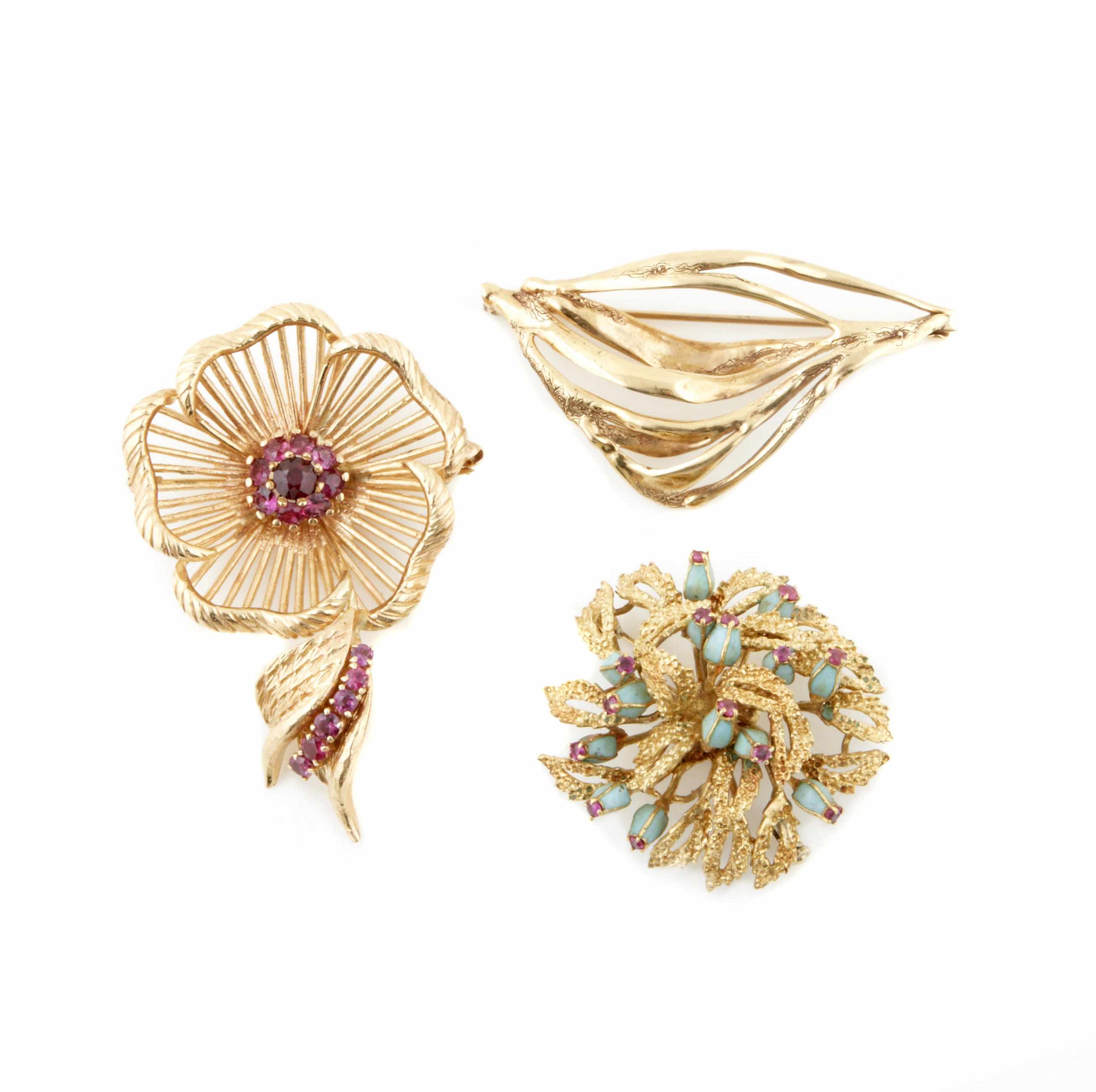 Appraisal: A collection of three gem-set and gold brooches g gross