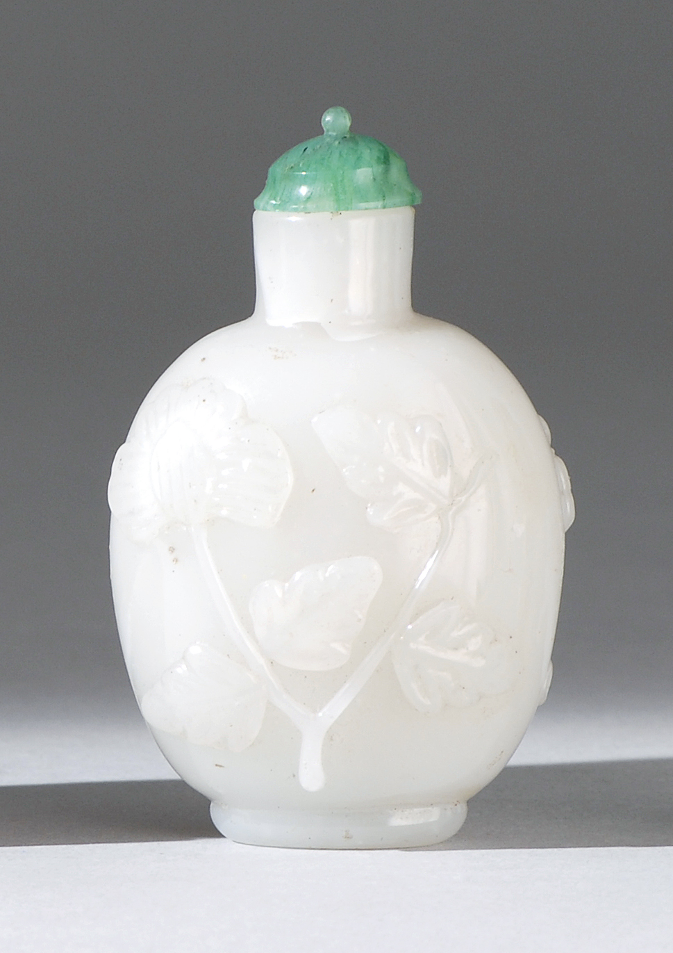 Appraisal: GLASS SNUFF BOTTLE Late th CenturySimulating white jade with relief