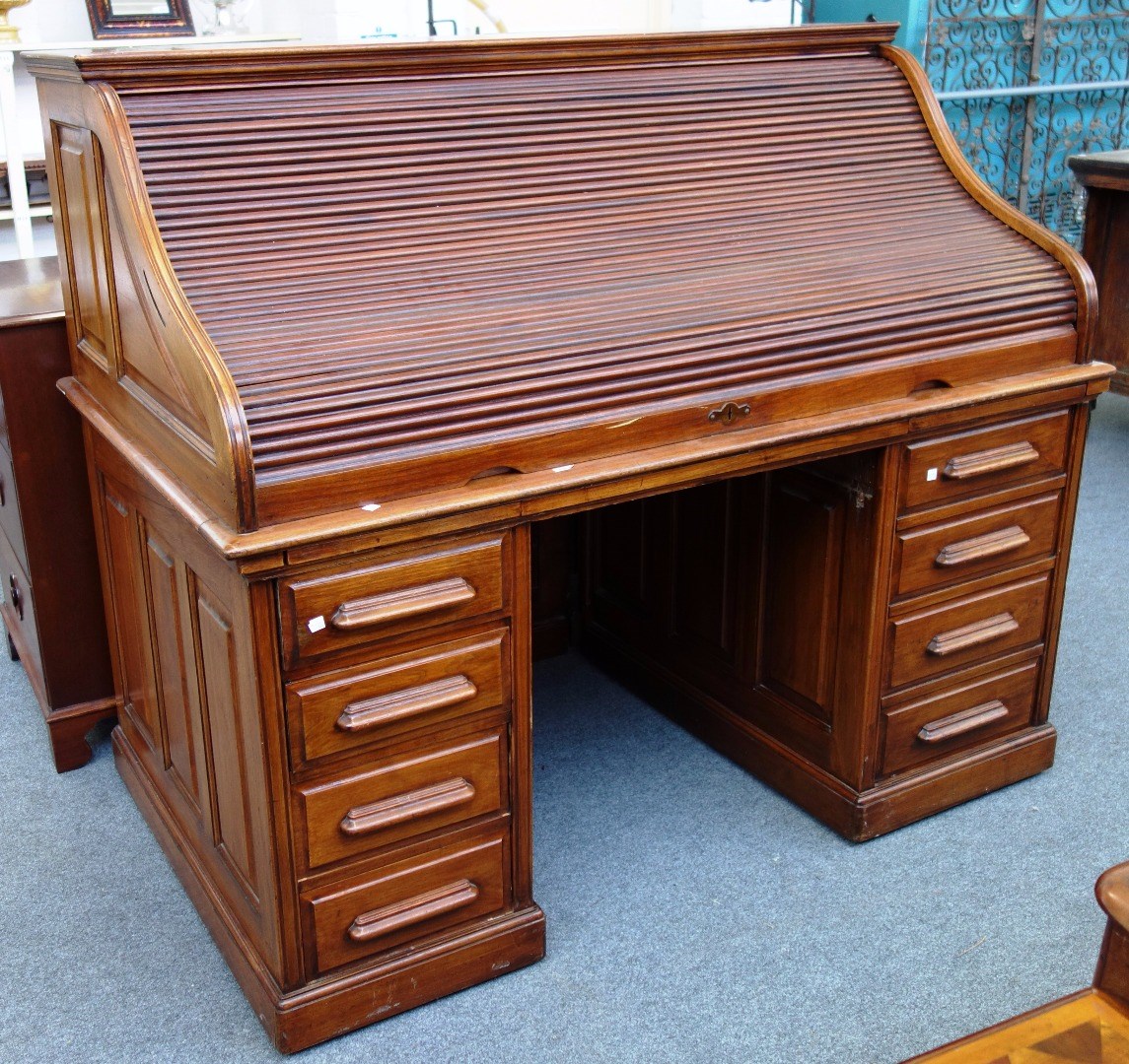 Appraisal: An early th century walnut roll top desk with fitted