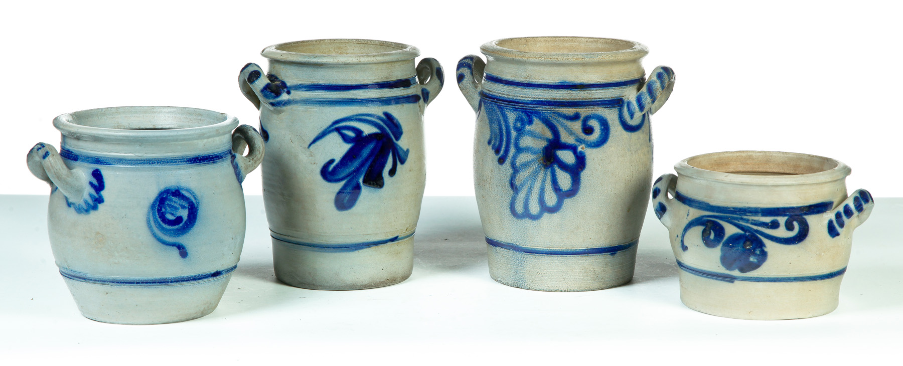 Appraisal: FOUR GERMAN GRADUATED DOUBLE-HANDLED STONEWARE JARS Nineteenth century Salt glaze