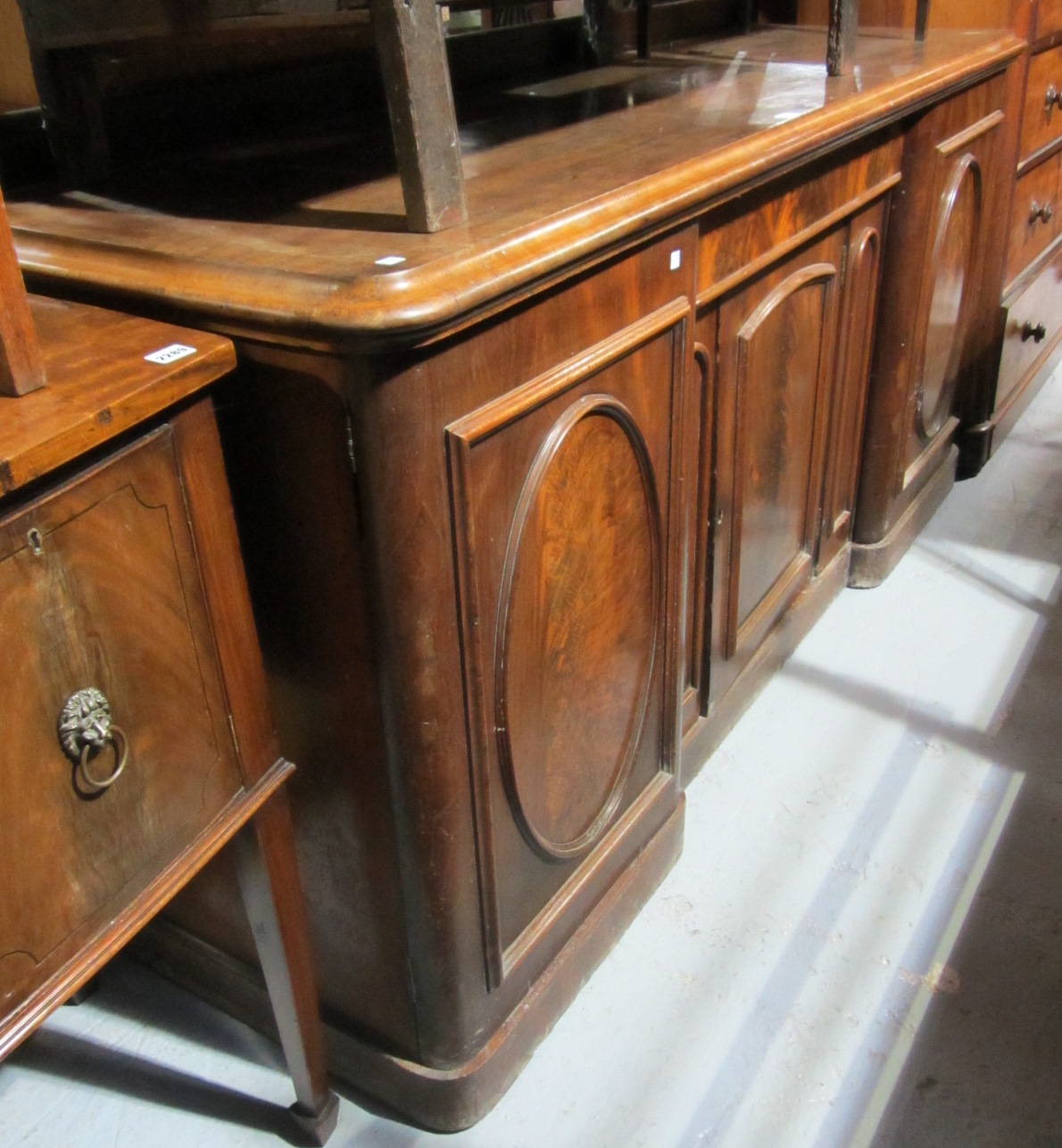 Appraisal: A Victorian mahogany sideboard with three arch panel doors and