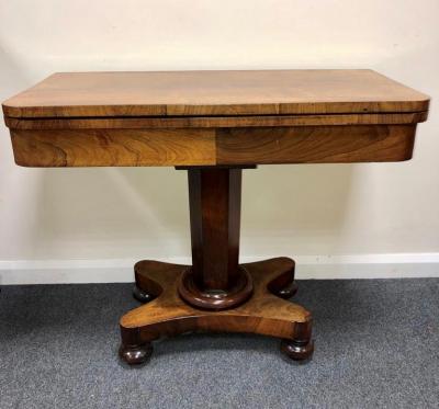 Appraisal: A Victorian rosewood fold-over card table on hexagonal column and