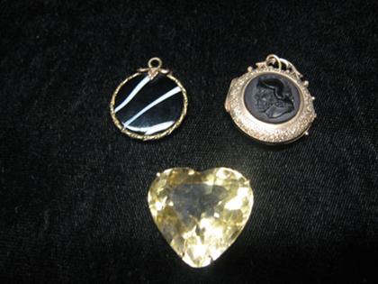 Appraisal: Three gold necklace charms Locket with black glass portrait of