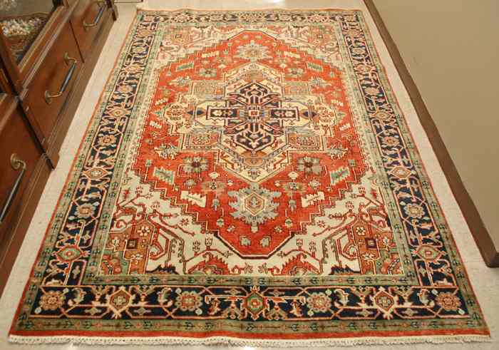 Appraisal: HAND KNOTTED ORIENTAL AREA RUG Persian Serapi design central geometric