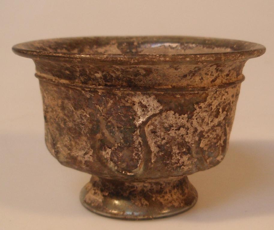 Appraisal: A post-Roman or early Islamic greenish footed glass bowl the