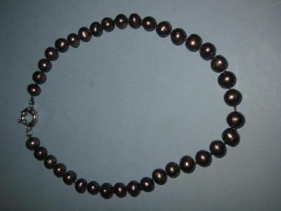 Appraisal: A CULTURED BLACK PEARL NECKLACE the beads with white metal