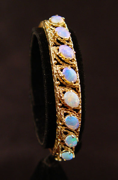 Appraisal: K OPAL BANGLE BRACELET K yellow gold bangle bracelet with