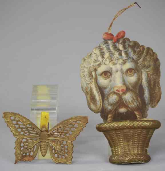 Appraisal: SCRAP FACE DOG W BASKET BUTTERFLY DRESDENS German scrap face