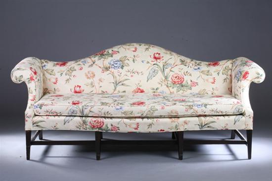 Appraisal: CHIPPENDALE STYLE CAMELBACK SOFA th century printed floral upholstery Serpentine