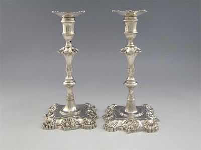 Appraisal: Two similar cast candlesticks on shaped square bases with shell