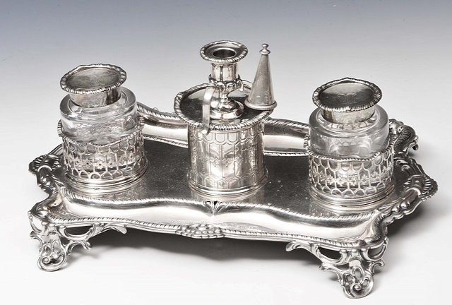 Appraisal: A VICTORIAN SILVER DESK STAND shaped base with shell and