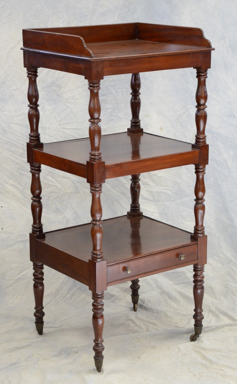 Appraisal: tier Regency mahogany dumb waiter scalloped backsplash at top drawer